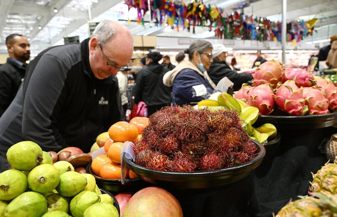 Shoppers select colorful produce, including rambutan fruit, at Vallarta, which opened its latest grocery store in Clovis with a ribbon cutting and huge crowds Wednesday, Nov. 20, 2024 in Clovis.