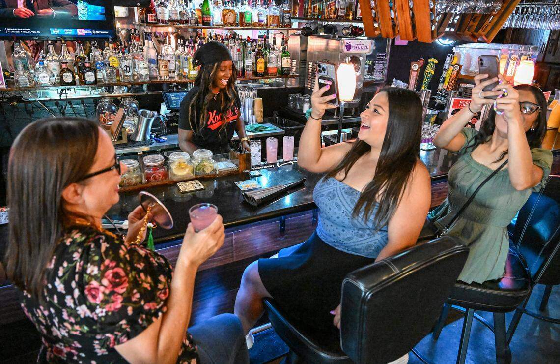 Friends snap photos at the bar while celebrating together at Kocky's Bar & Grill in downtown Fresno during their Butta Brunch on Sunday morning, Aug. 10, 2025.