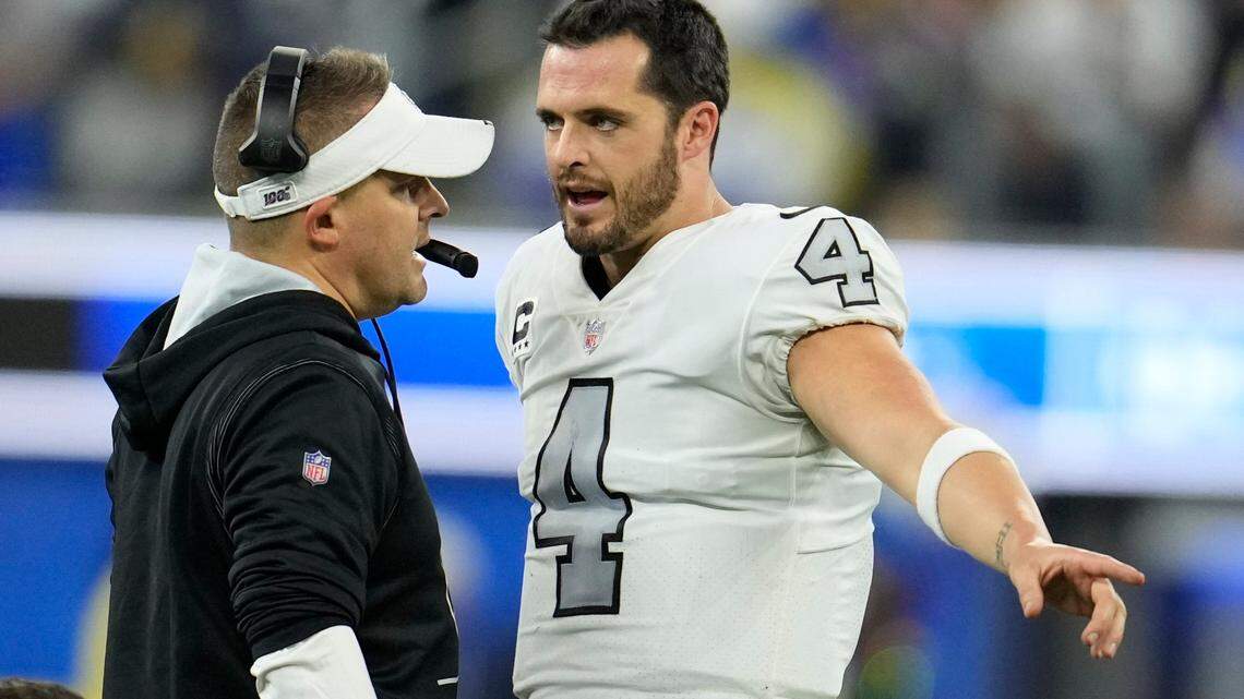 Las Vegas Raiders head coach Josh McDaniels, left, talks with quarterback Derek Carr during the second half of an NFL game against the Los Angeles Rams, Thursday, Dec. 8, 2022, in Inglewood, Calif.