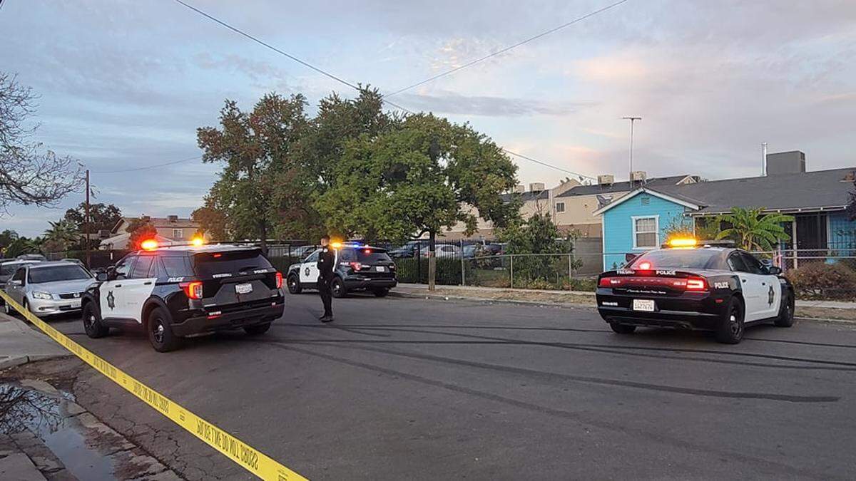 Police tape off the street in front of a Fresno, California apartment complex where a 15-year-old boy was shot in the leg Thursday, Oct. 21, 2021