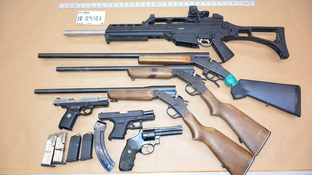 Police recovered multiple firearms and a high-capacity magazine from a man they reported is an ex-felon banned from owning firearms.