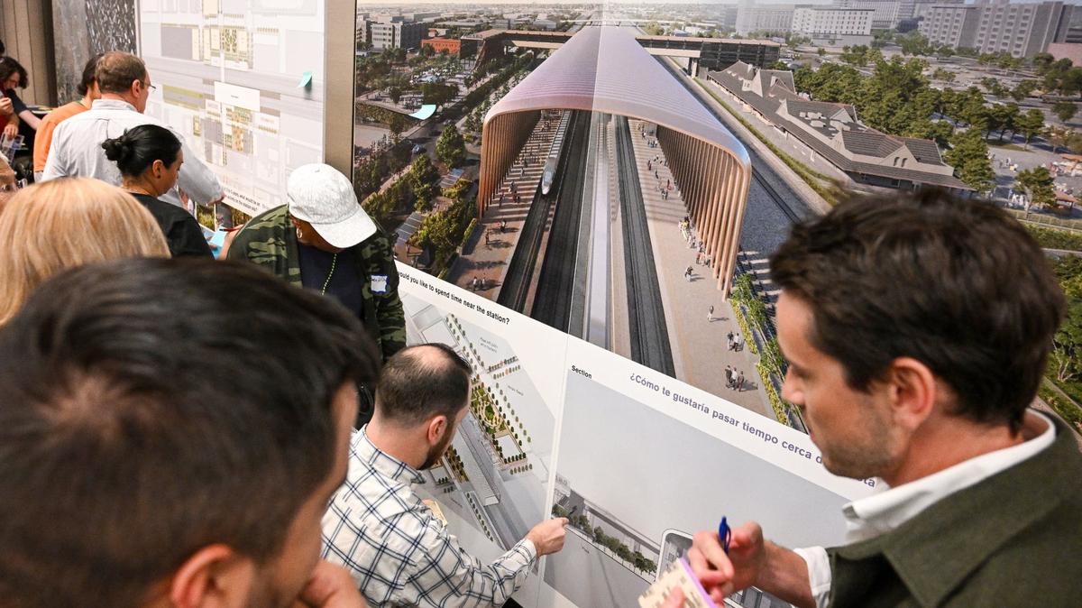 Residents and other interested parties look over plans and renderings that show what’s envisioned for the future Fresno Station of California’s High-Speed Rail project during an informational open house by the High-Speed Rail Authority at the Hilton DoubleTree in downtown Fresno on Wednesday, May 1, 2024.