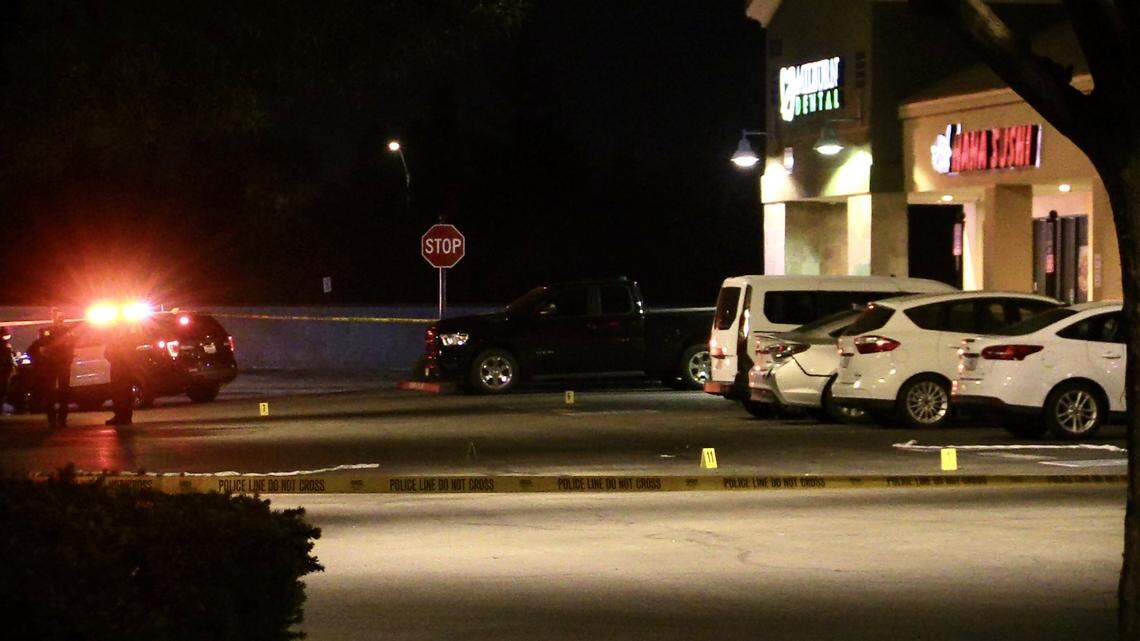 Evidence markers are placed at Herndon Place at Milburn Avenue after one person was killed and another critically injured in Fresno, California on Sunday, Feb. 19, 2023. The second person later died at the hospital, police said.