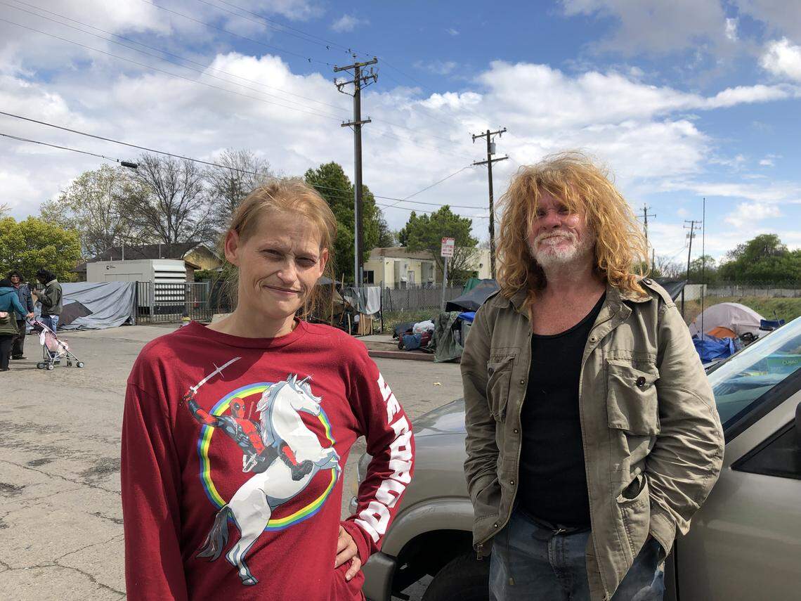 Homeless Fresnan Andrea Harper stands on Santa Clara St. outside the Poverello House with Jerry Mulford. She fears she’ll be at greater risk for coronavirus or an anxiety attack inside the county’s new shelter emergency shelters.