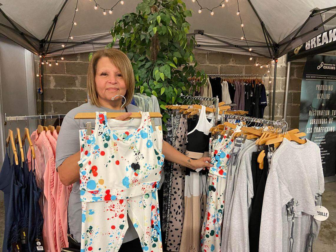 Irma Polanco, CEO of Smashing 350HP, shows off a set of leggings and a sports bra that she designed. Each purchase of the set gives $5 to an organization that benefits people with autism.
