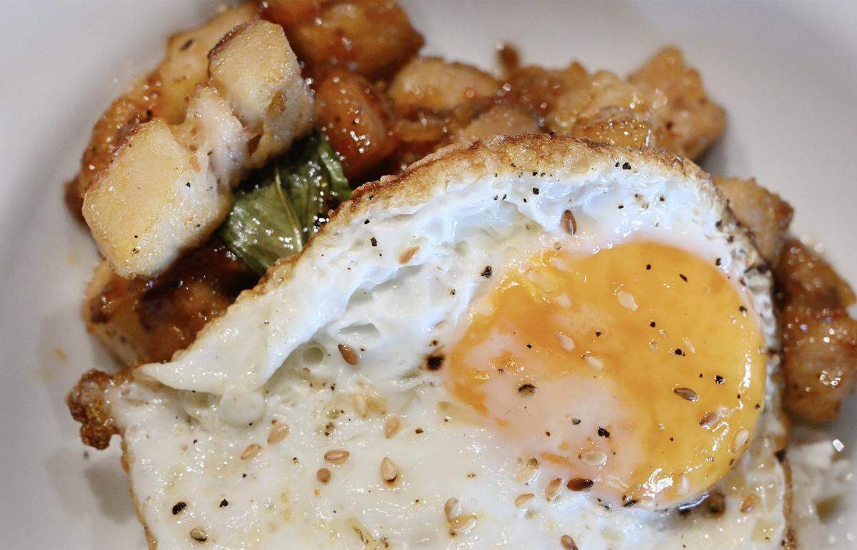 Pork belly, pan seared with sweet chili sauce and served with fresh basil and a fried egg, has become a favorite at Cracked Pepper Cafe, says Vatche Moukhtarian, who started offering counter service breakfast and brunch at his Cracked Pepper Bistro. Photographed Tuesday, March 10, 2026 in Fresno.