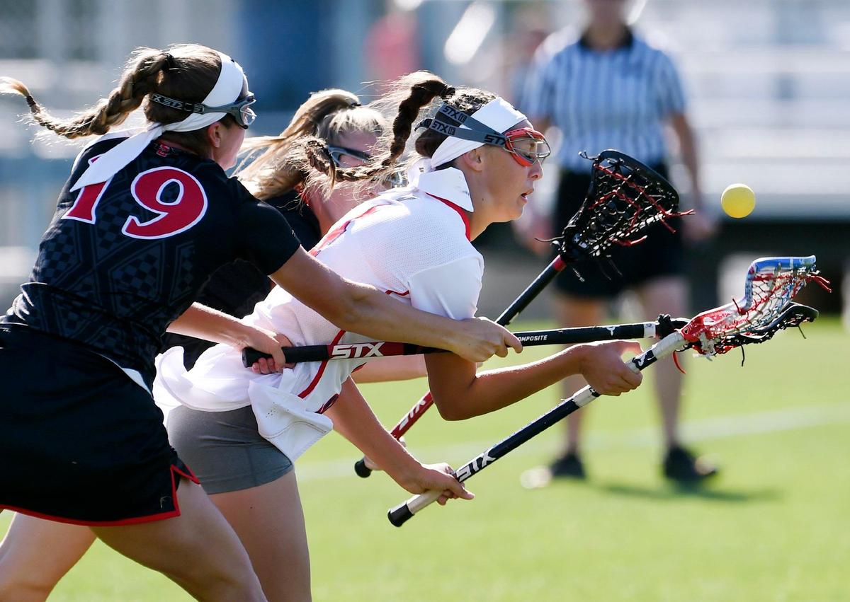 Fresno State’s Kayla Galet, center, moves the ball between San Diego State’s Kayla Deitz, foreground, and Kristen Hickey, background, in women’s lacrosse Monday, April 3, 2017 in Fresno.