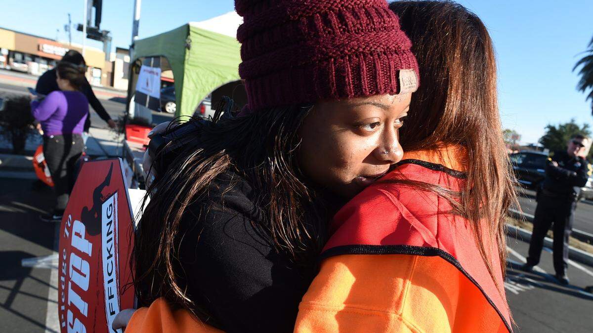 Debra Rush, co-founder and CEO of Breaking the Chains, right, hugs a young victim advocate, left, who requested anonymity, during the 2017 Stop Traffic to Stop Trafficking event in Fresno.
