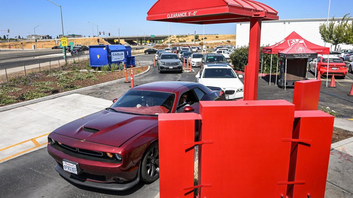 Cars pull up to the ordering kiosk in the drive-thru lane at Chick-fil-A’s River Park location at Blackstone and Nees in Fresno on Monday, Aug. 7, 2023.