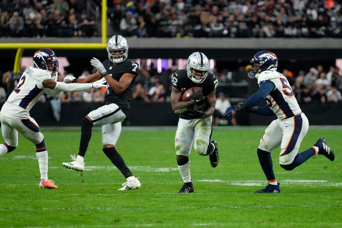 Las Vegas Raiders running back Josh Jacobs rushes during the second half of an NFL game against the Denver Broncos, Sunday, Dec. 26, 2021, in Las Vegas.