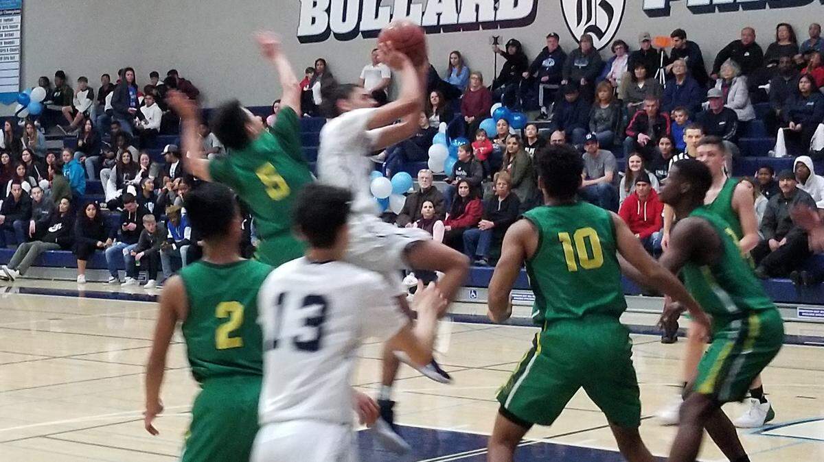 Bullard senior guard Chris Estrada splits the St. Joseph defense Friday night.