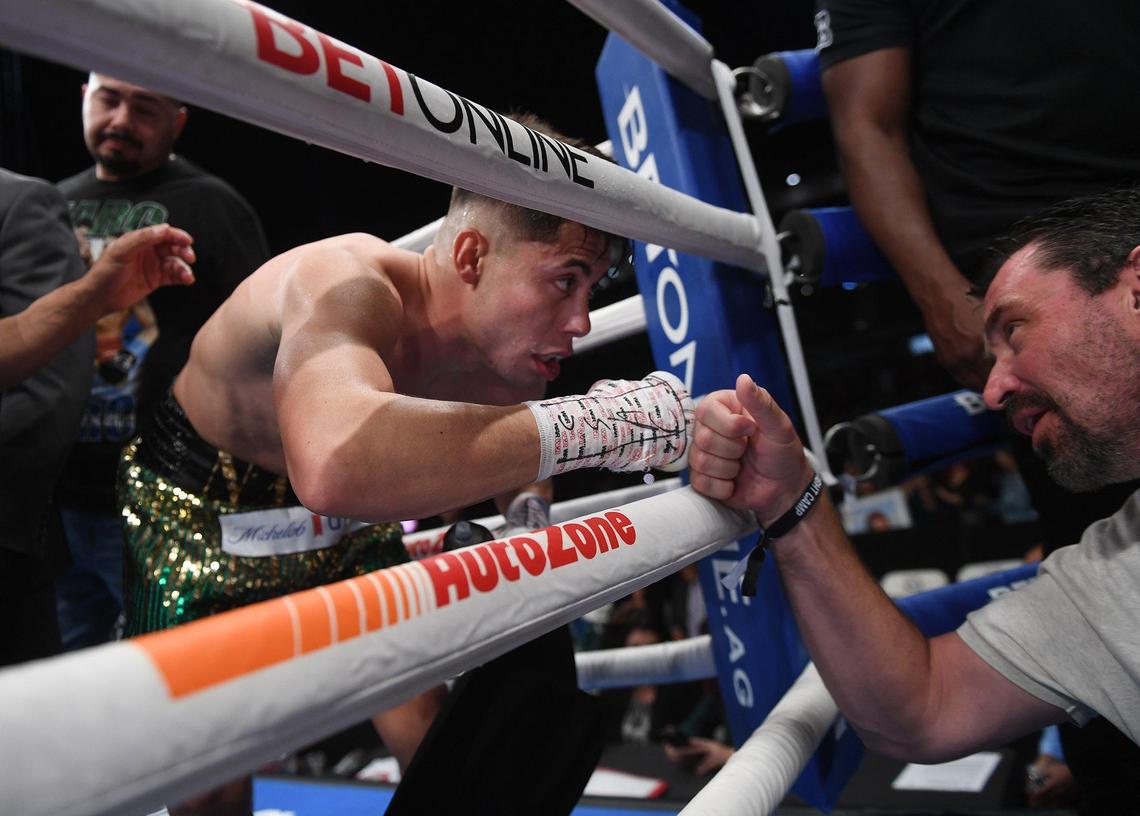 Fresno’s Marc Castro, center, fist-bumps an unknown man after stopping Angel Luna in the first round at a Matchroom Boxing event held at Chukchansi Park, Saturday, Oct. 16, 2021 in Fresno.