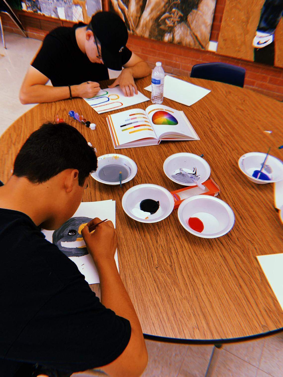 Fresno Unified students do painting activities as they take a break from working on a mural at McLane High School.