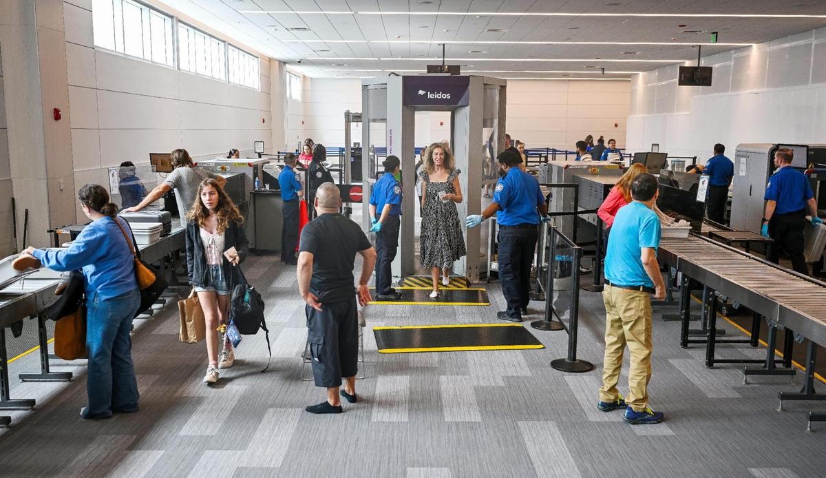 Travelers make their way through an expanded security checkpoint, which was officially unveiled to the public during a ceremony at Fresno Yosemite International Airport on Wednesday, April 23, 2025.