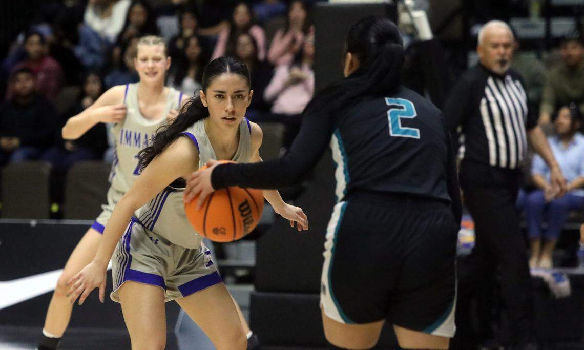 Immanuel High’s Elizabeth Dávila defends Mendota High’s Bethany Oliva during her team’s 41-29 win over Mendota High in the CIF Central Section Division IV championship game at Selland Arena on Feb. 23, 2024.