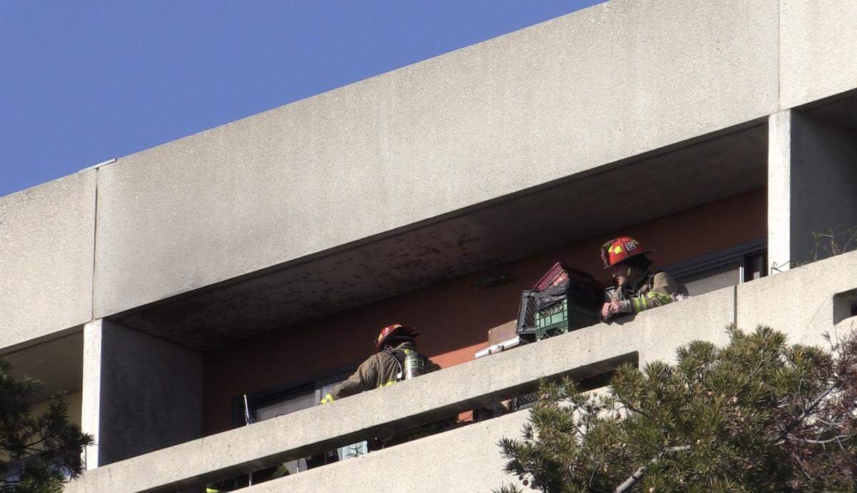 Fire crews investigate a fire that started on a balcony in downtown Fresno, California on Friday, March 31, 2023.