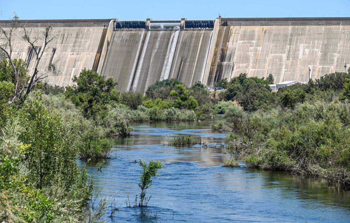 Water from Millerton Lake is just starting to flow over the spillway of Friant Dam and into the San Joaquin River in Friant on Thursday, July 13, 2023.