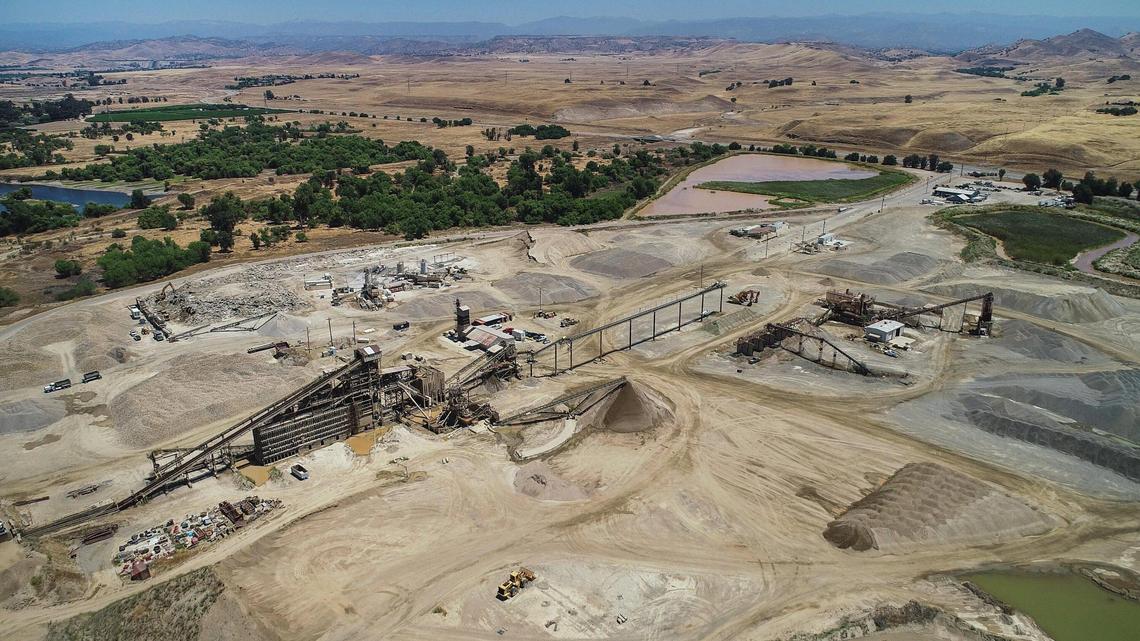 The CEMEX Rockfield aggregate plant site along Friant Road northeast of Fresno, near the San Joaquin River, is seen in this drone image from June 2020. The sand- and gravel-mining company is seeking a four-year extension from the county of Fresno through mid-2027 for its operating permits for the plant and a nearby quarry site.