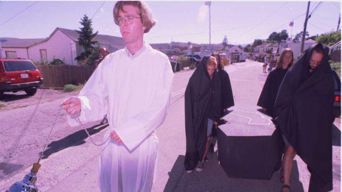 Outside the gates of San Quentin State Prison on May 2, 1996, Dan McCormick leads a mock funeral procession protesting the execution of Keith Daniel Williams. McCormick and protestors in black were members of Bay Area Death Penalty Activists Team. McCormick said, “every man, woman and child in the state of California will share in this violent act” – referring to the execution. Williams was executed after midnight May 3, 1996.