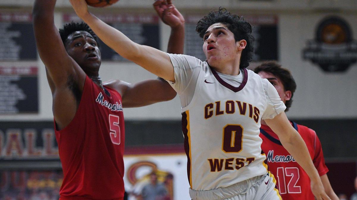 Clovis West’s Issac Martinez, right, goes up with San Joaquin Memorial’s Mike Davis Jr. to the left, in a semifinal of the Nike Invitational basketball tournament Dec. 10, 2021 in Fresno. Clovis West advanced to play in the championship Saturday night with a final score 68-62 over Memorial.