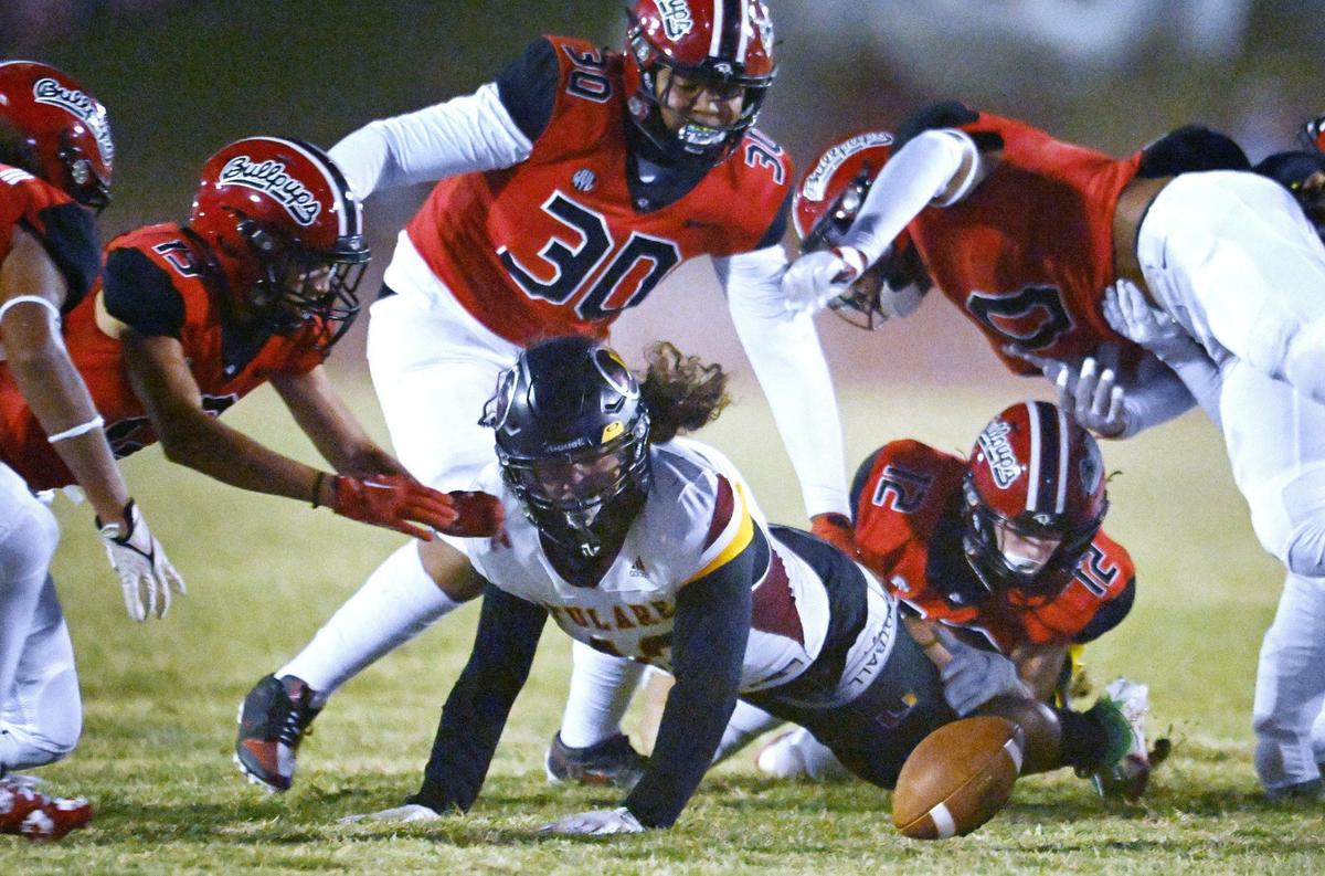 Tulare Union’s Dominic Wilson, bottom center, watches as he fumbles the ball on a run against Hanford in first half action Friday, Oct. 11, 2024 in Hanford.