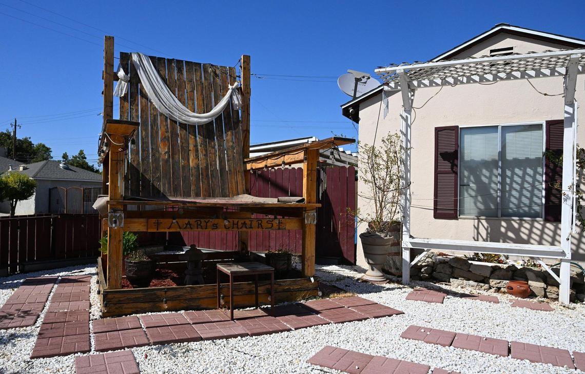 A large wooden chair sits in Robert Sandoval’s front yard along Shields Avenue. Robert said he constructed the chair in 2021 to memorialize his wife Mary Ann who died in a car crash in 2015. Photographed Sept. 26, 2024 in Fresno