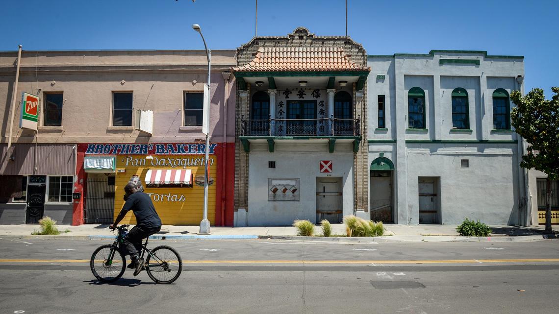 F Street in Fresno’s Chinatown appears nearly deserted during the lunchtime hour on Tuesday, April 28, 2020. Coronavirus orders have affected business in Chinatown already hit hard by high-speed rail construction road closures as well as the ongoing homeless problem.