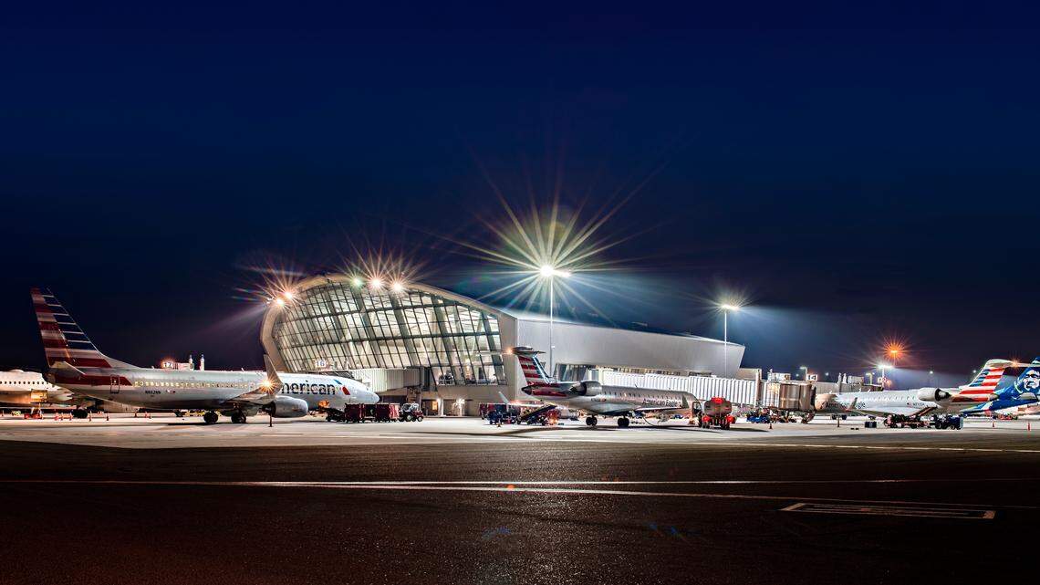 A nighttime view of Fresno Yosemite International Airport’s passenger terminal shows jets parked at the boarding gates.