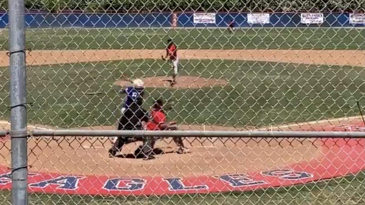 Kerman High pitcher Devon Daniel walks off the mound after the final out in a perfect game in the Lions’ 7-0 win over Firebaugh.
