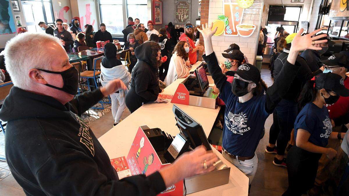 Rachel Dinnell, a server at the Raising Cane’s chicken restaurant in Clovis, greets customers during the restaurant’s 2021 grand opening. Across all jobs, women working full-time had significantly lower annual earnings than men both in the Fresno metro area and statewide in California.