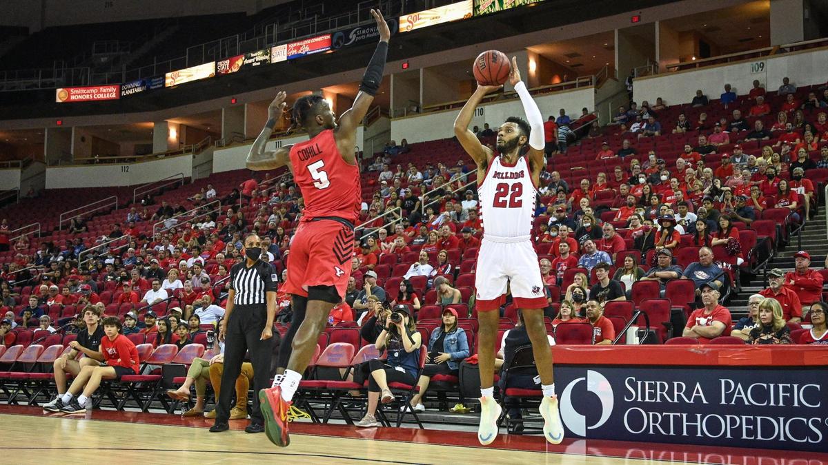 Fresno State’s Destin Whitaker, right, fires off a three-point shot while defended by Youngstown State’s Dwayne Cohill during their quarterfinal game in the 2022 Basketball Classic tournament at the Save Mart Center in Fresno on Wednesday, March 23, 2022.