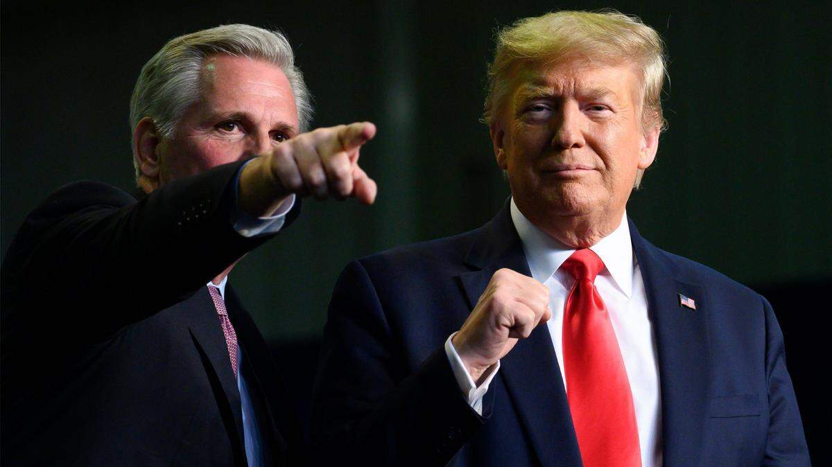 President Donald Trump, right, gestures next to then House Minority Leader Kevin McCarthy as they deliver remarks in Bakersfield on Feb. 19, 2020.