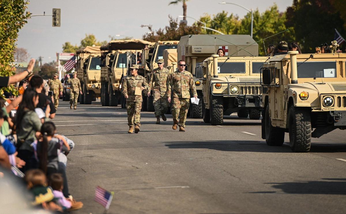 A convoy of U.S. Army military vehicles rumbles down Fresno Street during the annual Veterans Parade in downtown Fresno on Friday, Nov. 11, 2022.