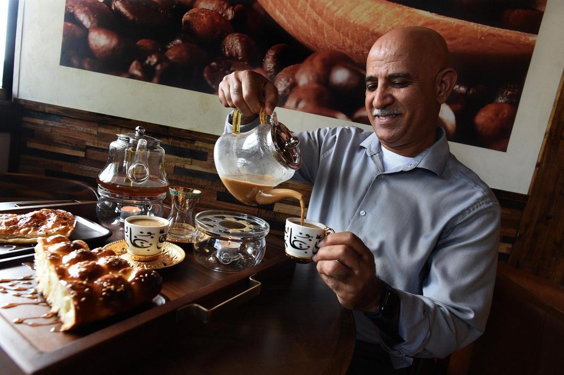 Yemen native Ahmed Ghazaly pours a cup of organic Turkish coffee, called mufawar, at his Bab-Al-Yemen Cafe. Each cup is prepared individually in a metal pot on a stovetop, with flavors and spices, such as cardamom, ginger, and cinnamon, and hundreds of years of tradition.