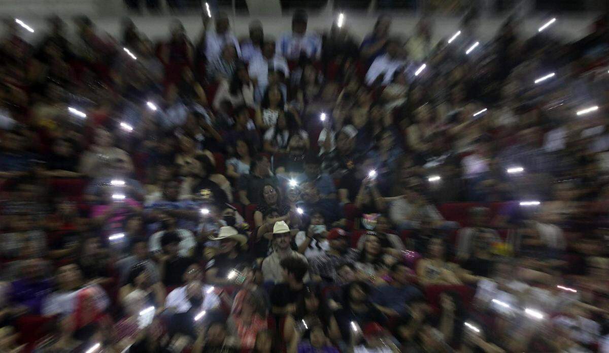 Family and friends of Fresno High School graduates brought out their cell phone flashlights during the graduation ceremony June 8, 2022 at the Save Mart Center.