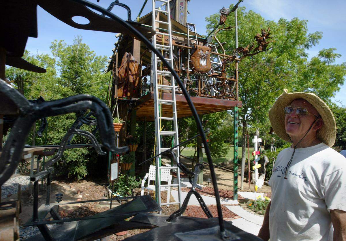 Former Fresno State track and field coach Red Estes looks over some of the creations he has made from mostly metal including a treehouse and a shrine to his coaching days at his Clovis home Wednesday, April 25, 2007. Estes is participating in a Clovis program called “Portal to Technology” which has artists making creations to meld art and technology for the city’s technology park.
