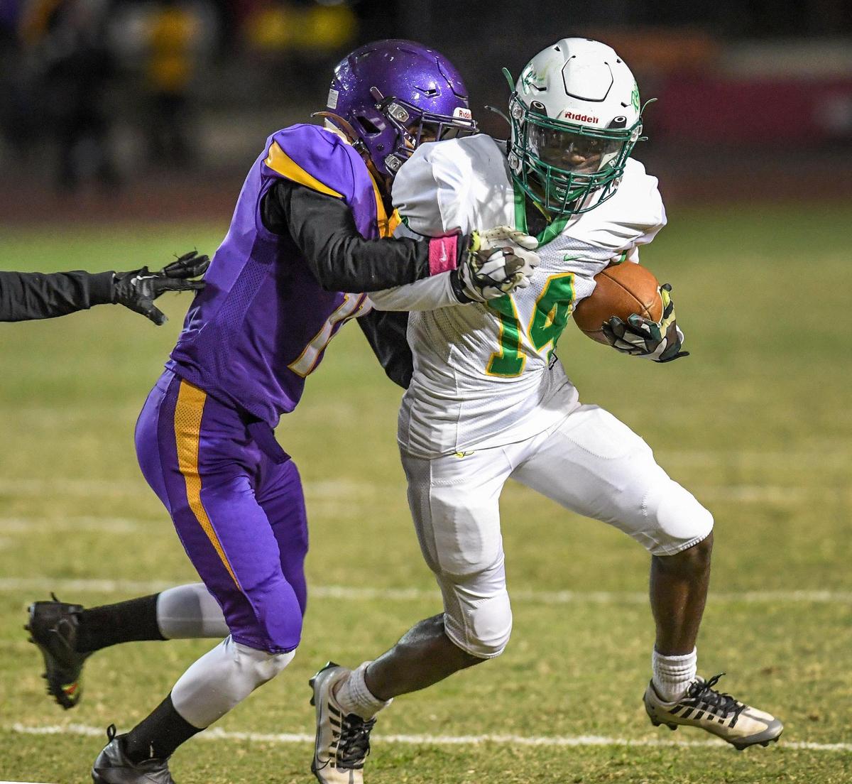 Roosevelt’s Jeremy Young gets caught from behind by Fresno’s Delbert Hall while trying to turn the corner on a run during the 92nd annual Little Big Game between the two schools at Ratcliffe Stadium in Fresno on Friday, Oct. 28, 2022.