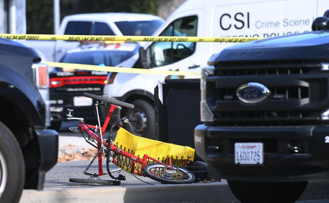 Police investigate the scene where a man in his 50s riding a bicycle was killed after being struck by a pickup truck at Friant Avenue and Audubon Drive next to Woodward Park Wednesday afternoon, Jan.12, 2022 in Fresno.