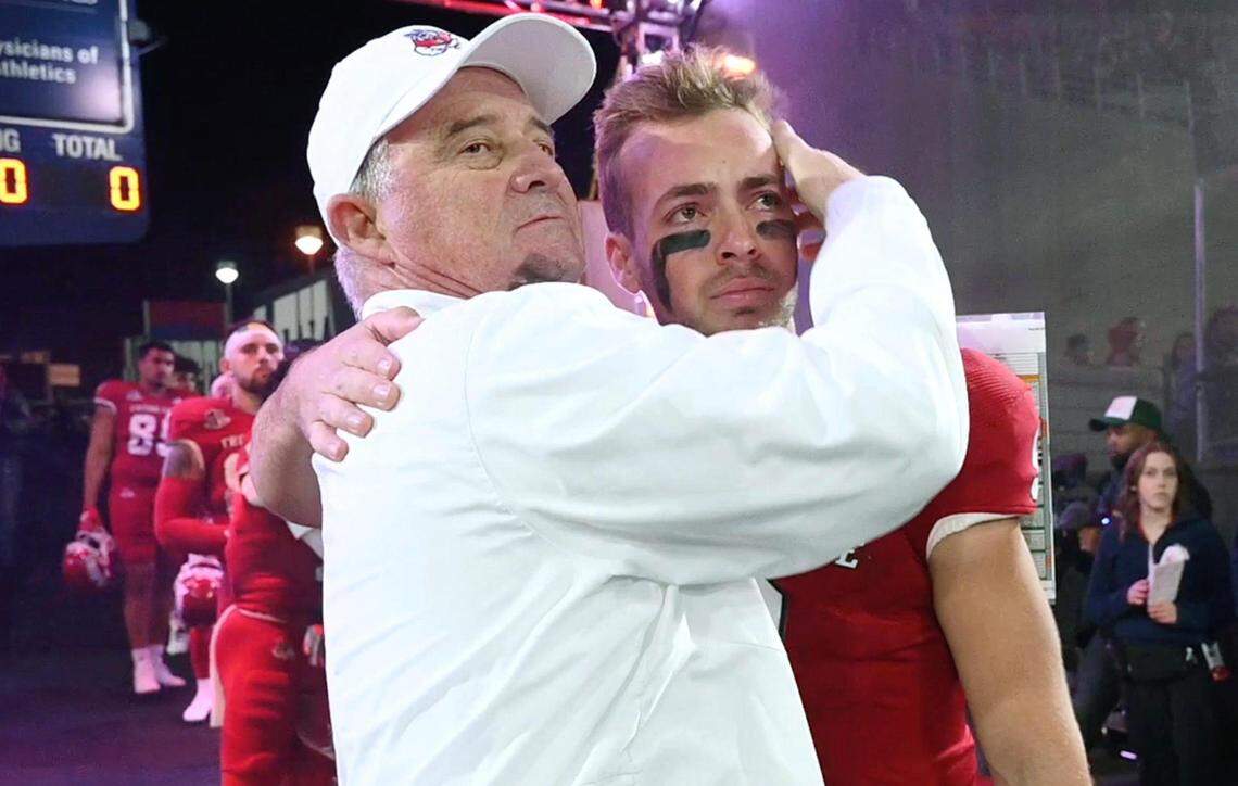 Fresno State coach Jeff Tedford embraces a tearful Jake Haener before the game against Wyoming on Friday, Nov. 25, 2022 at Valley Children's Stadium. The record-setting quarterback was one of 13 Bulldogs honored on Senior Night before Fresno State shut out Wyoming 30-0.