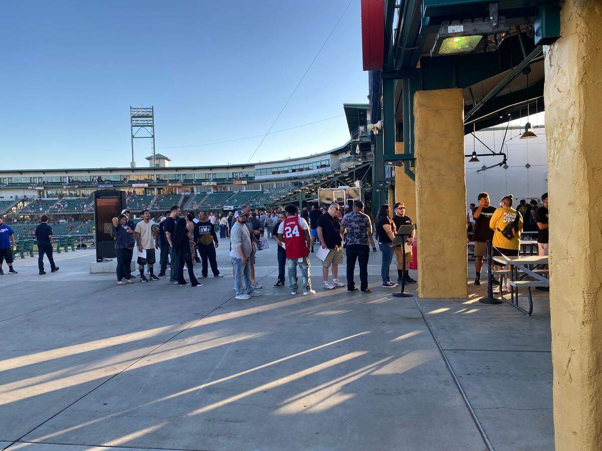 Fans wait their turn to meet with WWE Hall of Famer Kurt Angle at Chukchansi Park in Fresno, California on Saturday, Aug. 17, 2024.