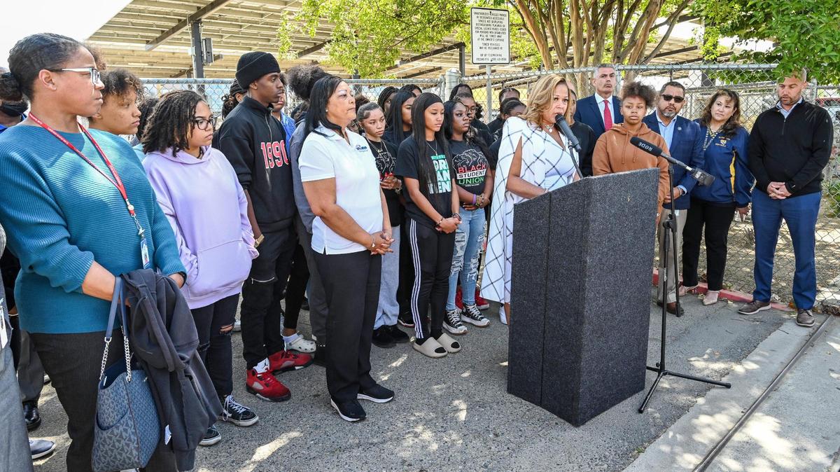 Fresno Unified School District Trustee Keshia Thomas, at lectern, stands with students from Edison and Bullard high schools, as well as community leaders, while addressing racist images that have appeared online recently.