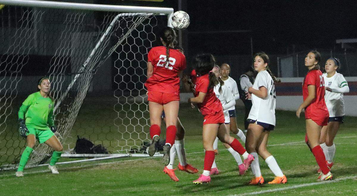 Sanger High freshman midfielder Kaylynn Foltz tries to head in a shot during a 2-1 non-conference win over Clovis East at Tom Flores Stadium on Dec. 14, 2023.