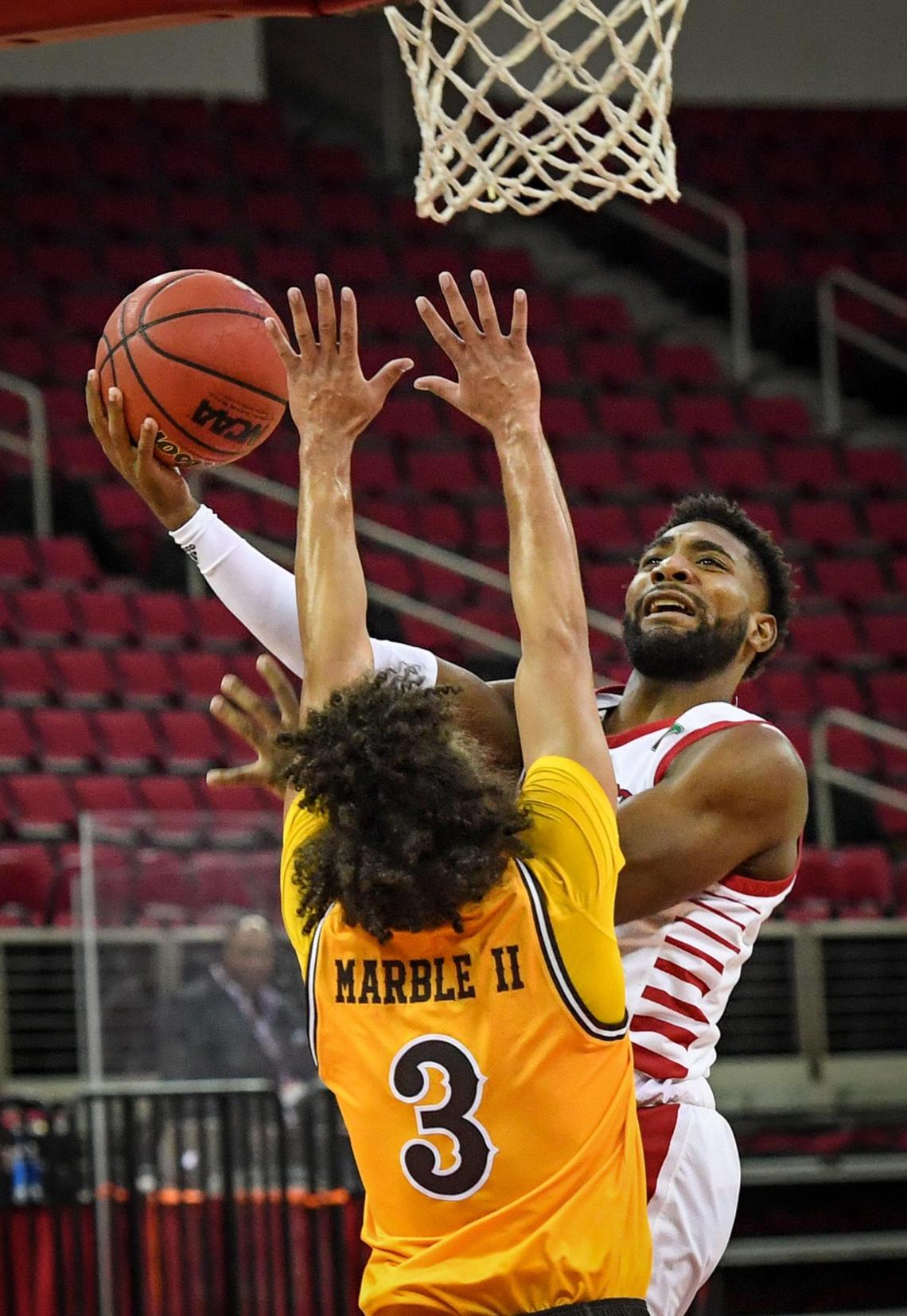 Fresno State guard Jordan Campbell, right, tries to get a shot up and around Wyoming’s Kwane Marble II during the Bulldogs’ 81-61 victory at the Save Mart Center on Monday, Jan. 4, 2021.