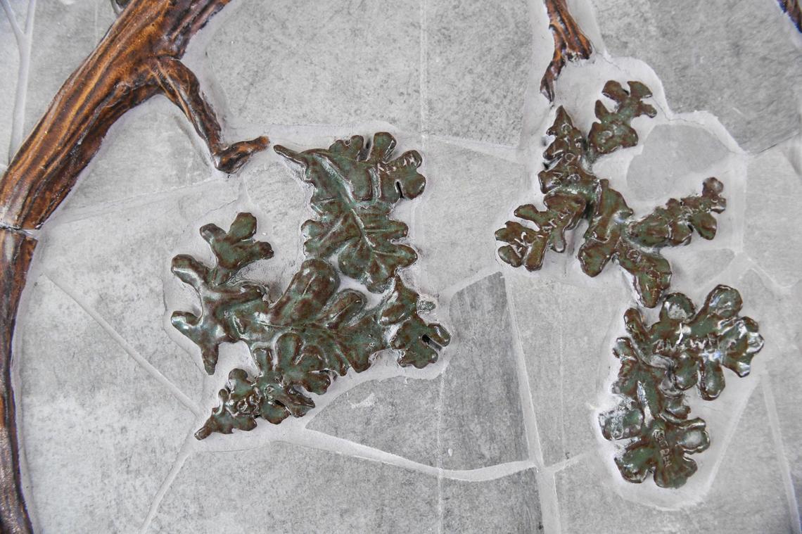 Porcelain leaves made by Manchester GATE sixth-graders are shown in the bas-relief and mosaic ceramic mural being installed by artist David Roberts at the school in Fresno on Tuesday, June 1, 2021.