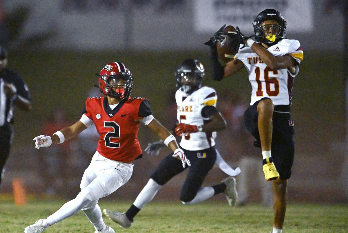 Tulare Union’s Malaki Knight, right, intercepts the pass intended for Hanford’s Anthony Perryman, left, in first half action Friday, Oct. 11, 2024 in Hanford.