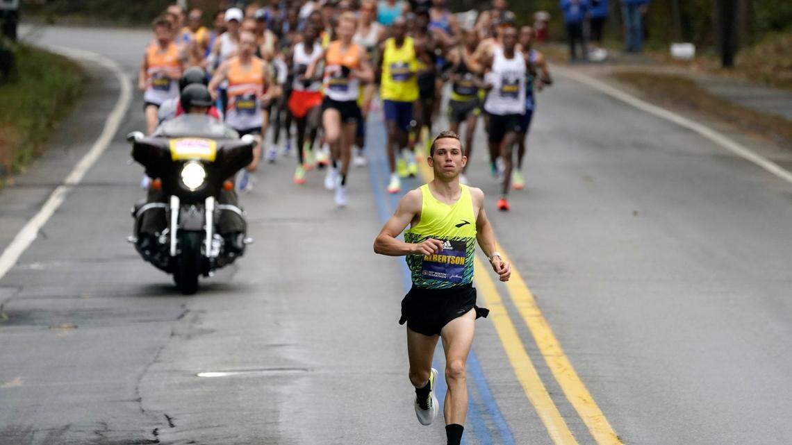 CJ Albertson, of Fresno, Calif., front, leads a group of elite men in the 125th Boston Marathon, Monday, Oct. 11, 2021, in Hopkinton, Mass. (AP Photo/Steven Senne)
