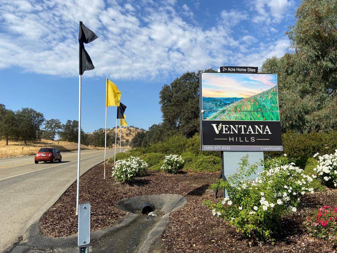 Flags and a sign mark the main entrance to Ventana Hills, a gated community of million-plus-dollar homes located 10 miles north of Clovis.