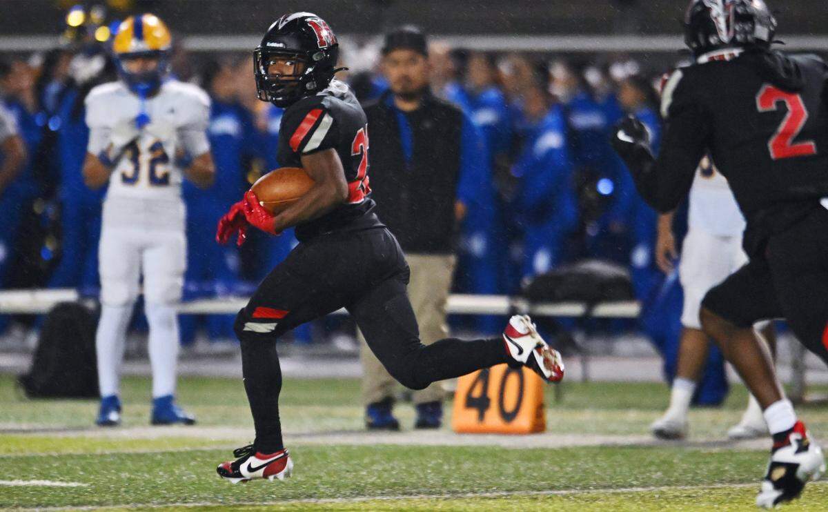McLane's Dimareea Banks runs away from the Dos Palos defense for a touchdown in th 3rd quarter in the Highlanders' 46-7 routing of the Broncos Friday, Nov. 14, 2025 in Fresno.