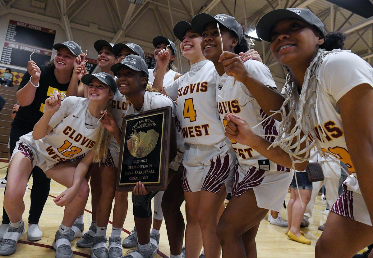 The Clovis West girls basketball team poses after its 53-36 win over Clovis in the Central Section Open Division girls basketball championship Thursday, June 10, 2021 in Fresno.