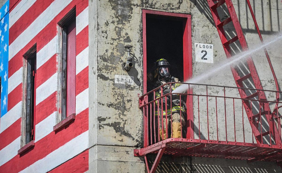 Rusty Davis, 14, of Clovis, operates a fire hose from the Fresno Fire Department’s training tower during their annual “Firefighter for a Day” event where citizens can get an inside look at the job of a firefighter, at the department’s training grounds in Fresno on Saturday, Oct. 22, 2022.